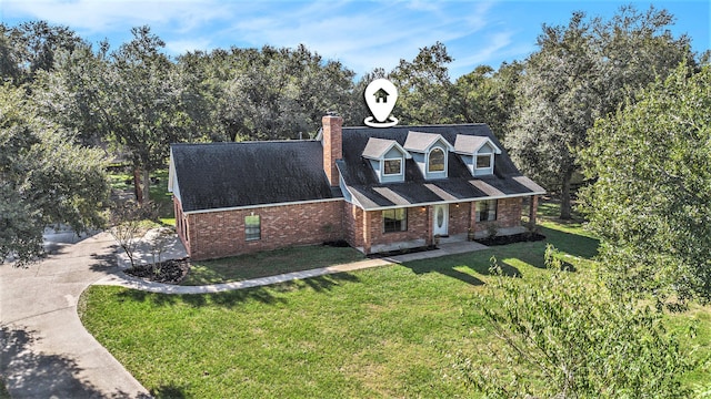 cape cod house featuring a front lawn