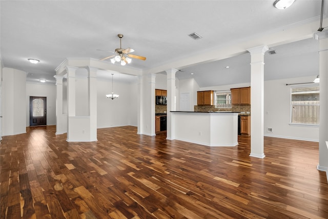 unfurnished living room featuring dark hardwood / wood-style floors, crown molding, and ceiling fan with notable chandelier