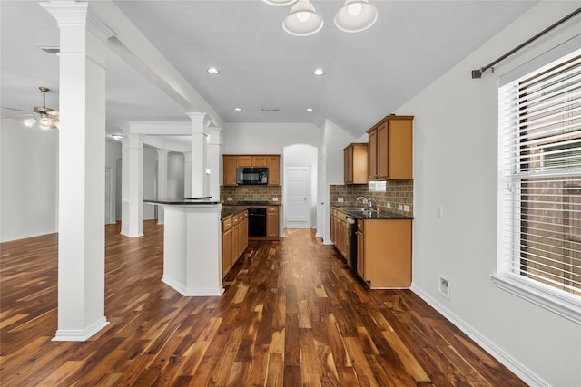 kitchen featuring ceiling fan, sink, dark hardwood / wood-style flooring, backsplash, and lofted ceiling