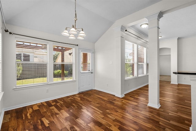 entrance foyer featuring vaulted ceiling, dark hardwood / wood-style floors, an inviting chandelier, and a healthy amount of sunlight