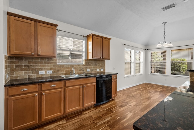 kitchen featuring sink, black dishwasher, a chandelier, vaulted ceiling, and hardwood / wood-style flooring