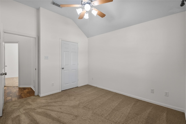 carpeted spare room featuring ceiling fan and lofted ceiling