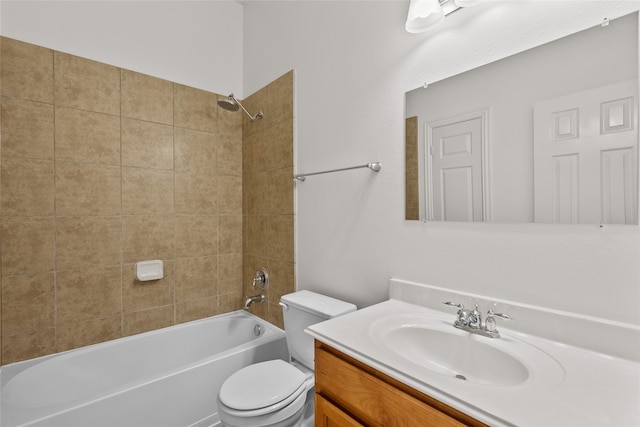 full bathroom with vanity, tiled shower / bath combo, and toilet