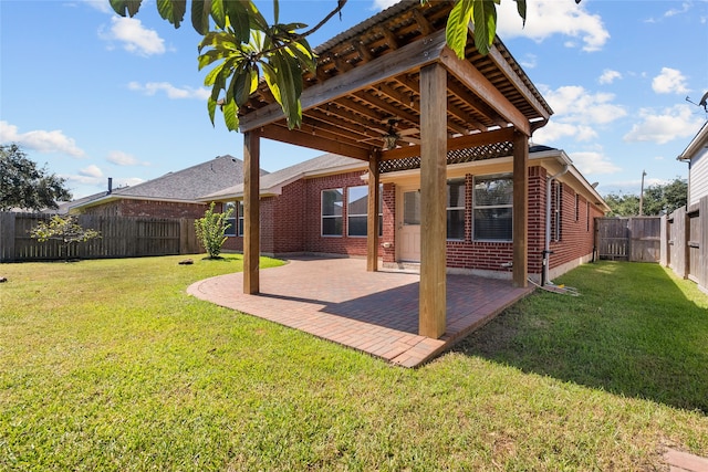 view of yard featuring ceiling fan and a patio