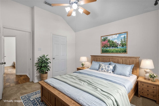 carpeted bedroom with ceiling fan and lofted ceiling