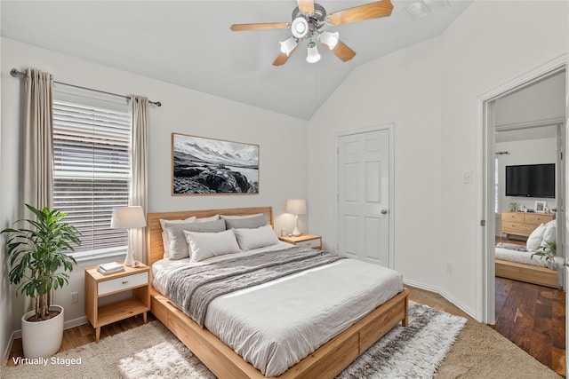 bedroom featuring hardwood / wood-style floors, ceiling fan, and vaulted ceiling