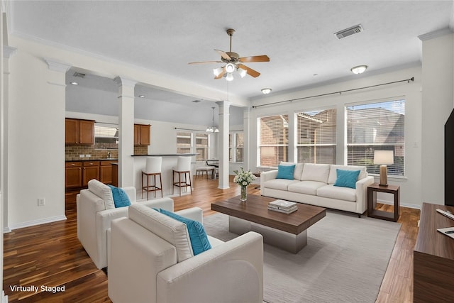 living room featuring ceiling fan, dark hardwood / wood-style flooring, and a wealth of natural light