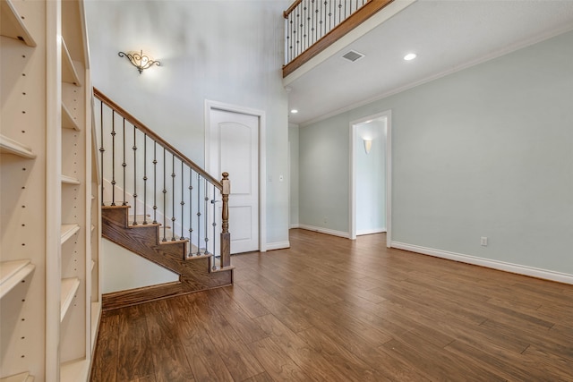 entrance foyer featuring wood-type flooring and ornamental molding