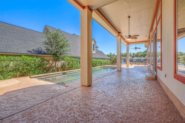 view of swimming pool with a patio and ceiling fan