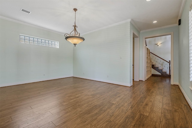 spare room featuring hardwood / wood-style floors and crown molding