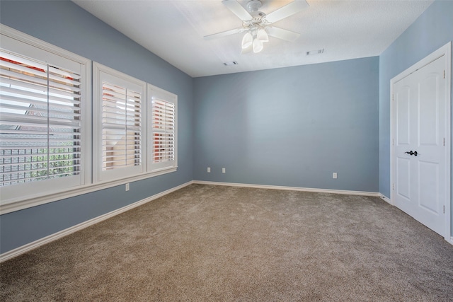 unfurnished room featuring carpet floors and ceiling fan