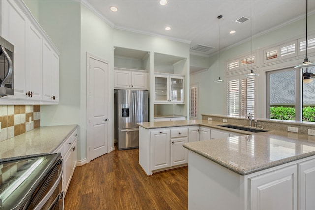 kitchen with dark wood-type flooring, white cabinets, stainless steel appliances, crown molding, and sink