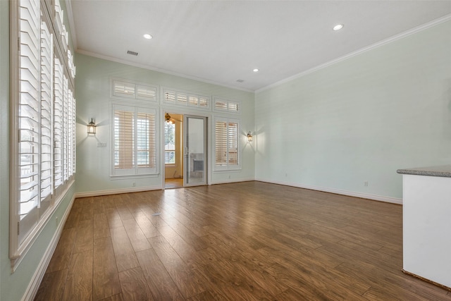 unfurnished room featuring ornamental molding and dark hardwood / wood-style floors