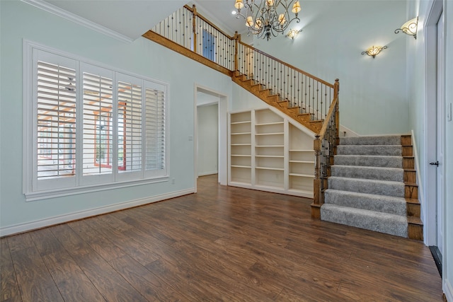 interior space with ornamental molding, dark hardwood / wood-style floors, and a chandelier