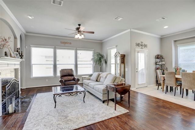 living room with hardwood / wood-style floors, ceiling fan, and plenty of natural light