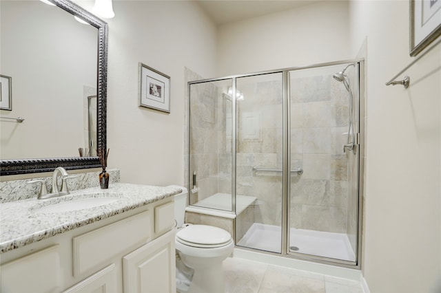 bathroom with toilet, walk in shower, vanity, and tile patterned flooring