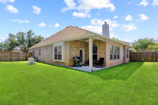 back of property featuring a patio area and a lawn