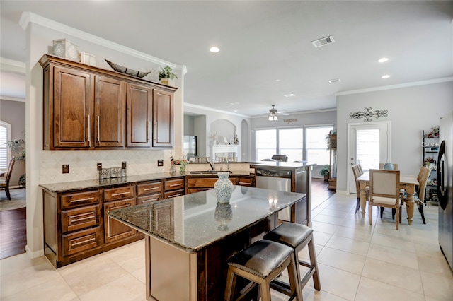 kitchen with crown molding, a center island, and kitchen peninsula