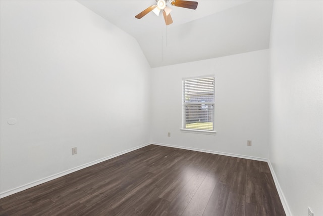 empty room featuring ceiling fan, vaulted ceiling, and dark wood-type flooring