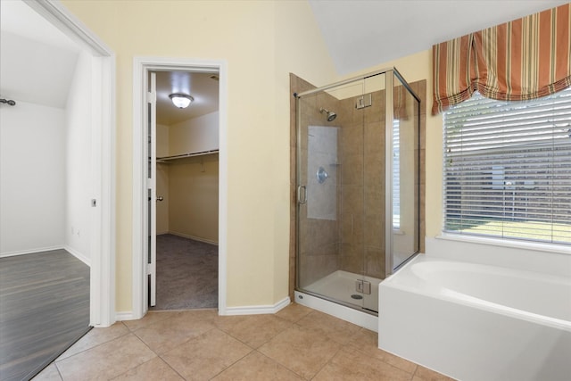 bathroom featuring vaulted ceiling, tile patterned floors, and shower with separate bathtub