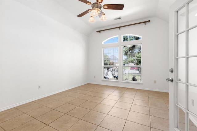 tiled spare room with ceiling fan and vaulted ceiling