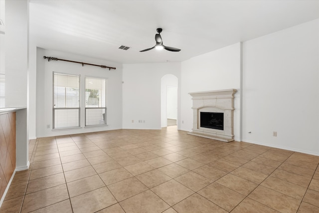 unfurnished living room featuring ceiling fan and light tile patterned floors