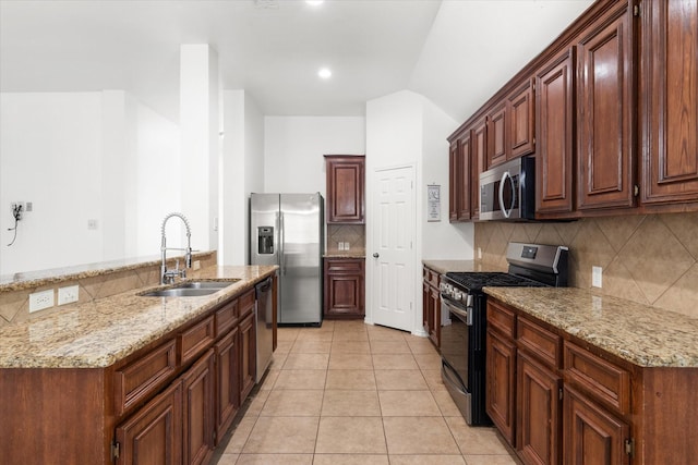 kitchen featuring tasteful backsplash, sink, stainless steel appliances, light tile patterned floors, and light stone counters