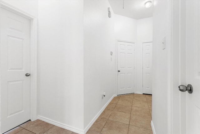 corridor featuring light tile patterned floors