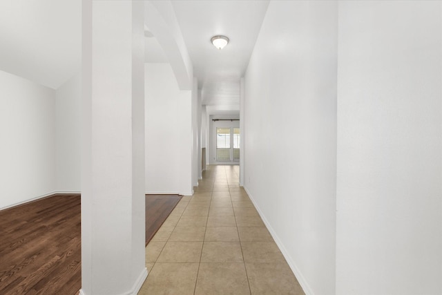 corridor featuring light tile patterned floors