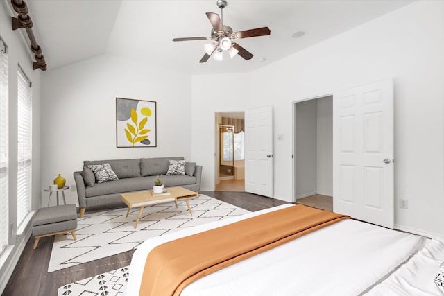 bedroom featuring ensuite bathroom, wood-type flooring, ceiling fan, and lofted ceiling