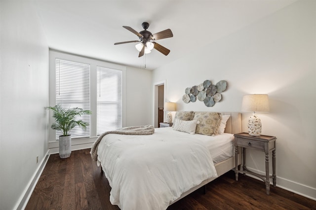 bedroom featuring ceiling fan, baseboards, and wood finished floors