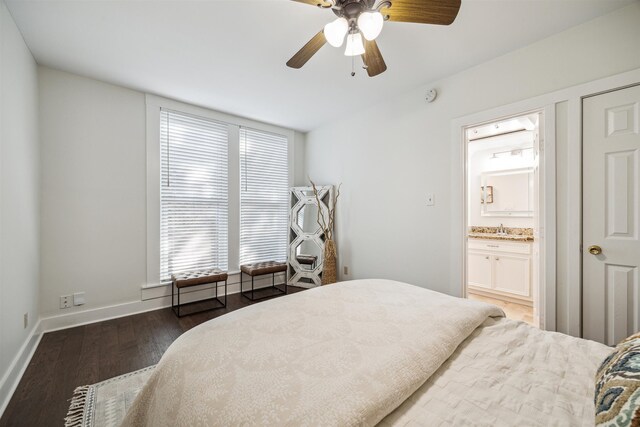 bedroom with baseboards, a ceiling fan, connected bathroom, wood finished floors, and a sink