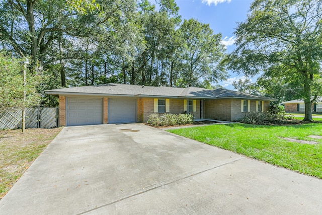 single story home featuring a garage and a front lawn