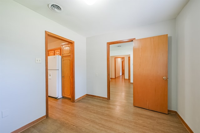 spare room featuring light wood-type flooring