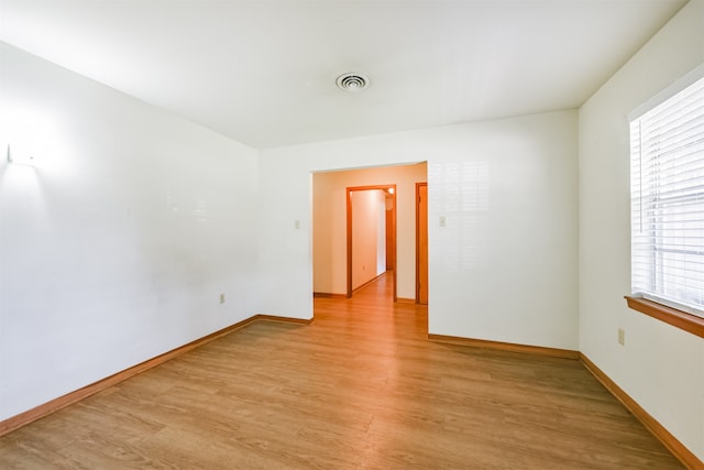 unfurnished room featuring light wood-type flooring and a wealth of natural light