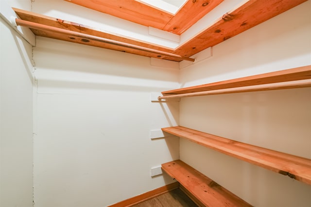 spacious closet featuring hardwood / wood-style flooring