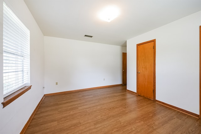 spare room with hardwood / wood-style floors