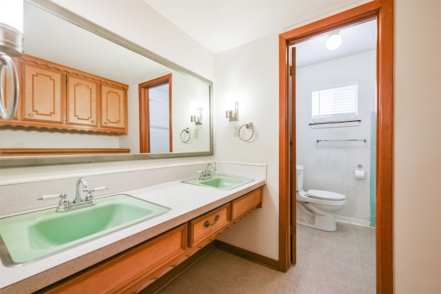 bathroom with vanity, toilet, and tile patterned floors