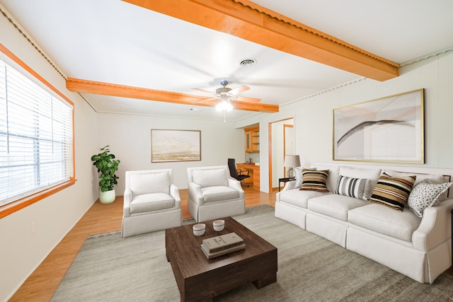 living room with light wood-type flooring, ceiling fan, and beamed ceiling