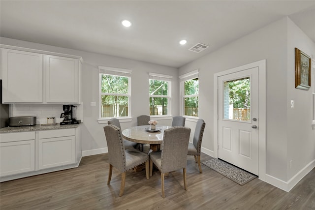 dining space with light hardwood / wood-style flooring