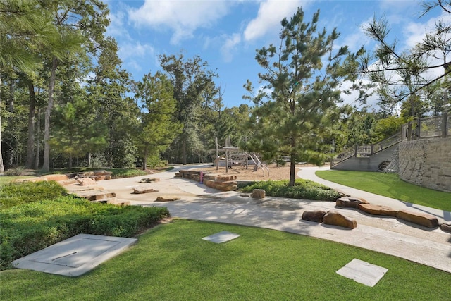 view of community with a yard and a playground