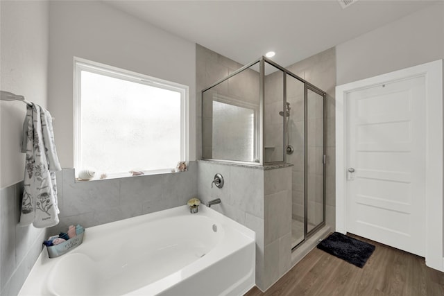 bathroom featuring hardwood / wood-style floors and shower with separate bathtub