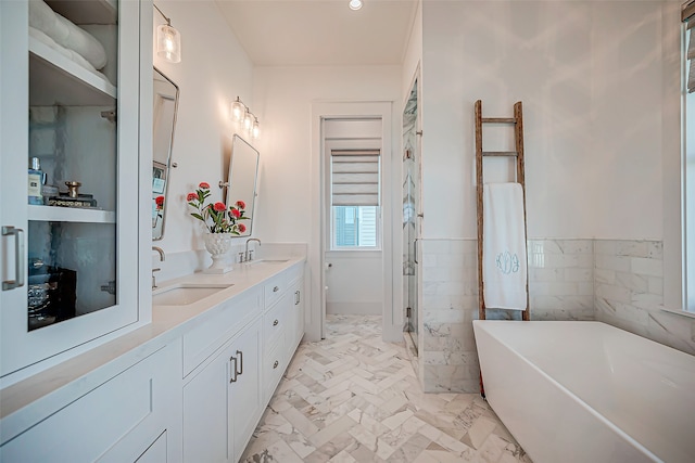 bathroom with plus walk in shower, vanity, and tile walls