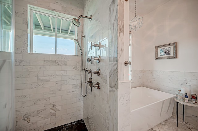 bathroom featuring shower with separate bathtub