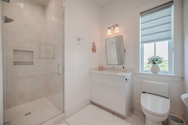 bathroom with vanity, a shower with shower door, and toilet