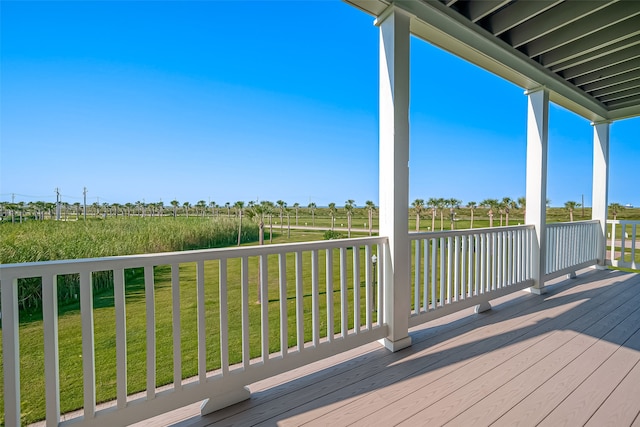 wooden terrace featuring a lawn