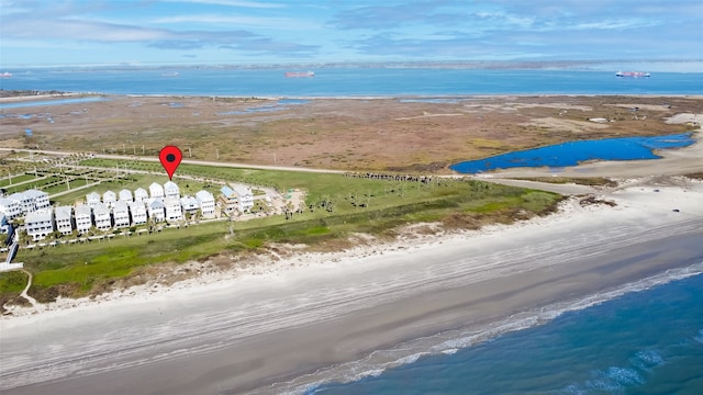 aerial view with a water view and a view of the beach