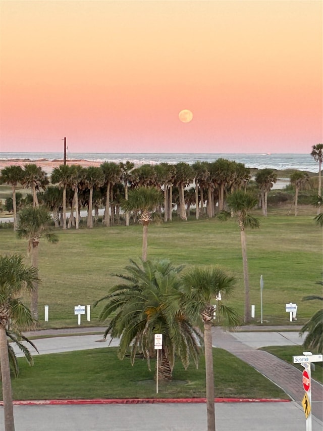 view of community with a lawn and a water view