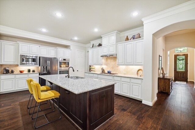 kitchen featuring stainless steel appliances, white cabinets, and sink