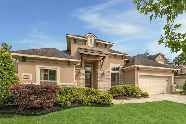 prairie-style house featuring concrete driveway, an attached garage, stucco siding, stone siding, and a front yard